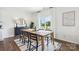 Dining area with wooden table, black chairs, and large window overlooking backyard at 3028 Ora Smith Rd, Lincolnton, NC 28092