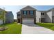 Two-story home with gray and brown siding, two-car garage, and a well-manicured lawn at 3028 Ora Smith Rd, Lincolnton, NC 28092