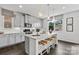 Modern kitchen with white cabinets, granite countertops, and island seating at 3312 Meadow Wood Ct, Maiden, NC 28650