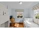 Charming bedroom featuring a fireplace, daybed, and a window offering natural light at 373 Hillside Ave, Charlotte, NC 28209