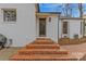 Charming brick steps leading to the home's entrance, surrounded by lush landscaping at 373 Hillside Ave, Charlotte, NC 28209