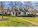 Charming brick home with manicured lawn, brick walkway, and covered front porch swing at 373 Hillside Ave, Charlotte, NC 28209