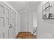 Bright hallway with hardwood floors and access to rooms with white doors at 373 Hillside Ave, Charlotte, NC 28209