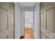 Hallway featuring closet doors leading to a bathroom with natural light at 373 Hillside Ave, Charlotte, NC 28209