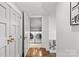 Hallway featuring closet doors and a view of the laundry area with washer and dryer at 373 Hillside Ave, Charlotte, NC 28209