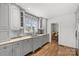 Bright kitchen with granite countertops, wooden floors, and gray cabinetry at 373 Hillside Ave, Charlotte, NC 28209