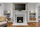 Cozy living room with fireplace, hardwood flooring and built-in shelving at 373 Hillside Ave, Charlotte, NC 28209