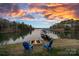 Relaxing lakefront view with firepit and chairs at 3917 Acacia N Rd, York, SC 29745