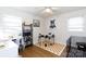 Bright bedroom with built-in shelving, a drum set, and a dog crate at 3988 Crestview Dr, Rock Hill, SC 29732