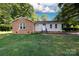 Charming single-story home with brick and siding exterior, set on a lush lawn with mature trees at 3988 Crestview Dr, Rock Hill, SC 29732