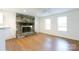 Bright living room features a stone fireplace, wood floors, and ample natural light from two windows at 3988 Crestview Dr, Rock Hill, SC 29732