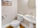 Clean bathroom with pedestal sink, toilet, and neutral colors at 4120 St Timms Ct, Charlotte, NC 28226