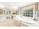 Elegant bathroom with soaking tub, double vanity, and large window at 4120 St Timms Ct, Charlotte, NC 28226