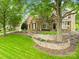 Two-story brick home with manicured lawn and retaining wall at 4120 St Timms Ct, Charlotte, NC 28226