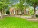 Brick house with landscaping and large trees at 4120 St Timms Ct, Charlotte, NC 28226