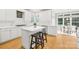 Spacious kitchen with white cabinets, island, and breakfast bar at 4120 St Timms Ct, Charlotte, NC 28226