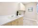 Well-lit laundry room with cabinets and a utility sink at 4120 St Timms Ct, Charlotte, NC 28226