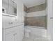 Neutral bathroom features a single sink vanity and a shower-tub combination with patterned tile at 413 Shinnville Rd, Mooresville, NC 28115