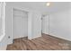 Well-lit bedroom with hardwood floors, white trim and ample closet space at 413 Shinnville Rd, Mooresville, NC 28115