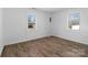 Inviting bedroom featuring wood-look floors, bright natural light, and a peaceful ambiance at 413 Shinnville Rd, Mooresville, NC 28115