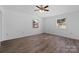 Bedroom featuring hardwood floors, white walls, and windows showcasing the neighborhood at 413 Shinnville Rd, Mooresville, NC 28115