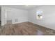 Clean bedroom with light-colored walls, hardwood floors, and ample natural light from the window at 413 Shinnville Rd, Mooresville, NC 28115