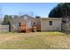 Exterior showcasing a backyard with a deck, grassy lawn, and a neutral-colored single-story home at 413 Shinnville Rd, Mooresville, NC 28115