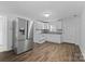 Bright kitchen featuring stainless steel refrigerator, white cabinets, and modern backsplash at 413 Shinnville Rd, Mooresville, NC 28115