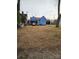 Small backyard with gravel and a blue house at 414 S Yadkin Ave, Spencer, NC 28159