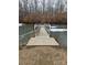 Wooden dock extending over a partially frozen pond at 414 S Yadkin Ave, Spencer, NC 28159