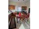 L-shaped kitchen with wood cabinets and white backsplash at 414 S Yadkin Ave, Spencer, NC 28159