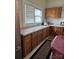 Kitchen with wood cabinets, granite countertops, and a window at 414 S Yadkin Ave, Spencer, NC 28159