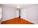 Bedroom with hardwood floors, plantation shutters, and closet at 4308 Glenfall Ave, Charlotte, NC 28210