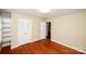 Bedroom with hardwood floors, closet, and access to another room at 4308 Glenfall Ave, Charlotte, NC 28210