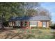 Brick ranch house with a landscaped lawn and mature trees at 4308 Glenfall Ave, Charlotte, NC 28210