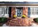 Brick front entrance with a black door and planter boxes at 4308 Glenfall Ave, Charlotte, NC 28210