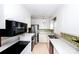 Kitchen with white cabinets, black appliances, and green tile at 4308 Glenfall Ave, Charlotte, NC 28210