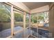 Screened porch overlooking backyard with view of trees and lawn at 4308 Glenfall Ave, Charlotte, NC 28210