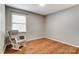 Bright bedroom with hardwood floors and a rocking chair at 4452 Huntington Dr, Gastonia, NC 28056