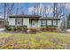 Ranch home with green siding, brick base, and landscaping at 4452 Huntington Dr, Gastonia, NC 28056