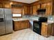 Kitchen with wood cabinets, stainless steel appliances, and tile flooring at 4452 Huntington Dr, Gastonia, NC 28056