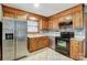 Bright kitchen, stainless steel appliances, wood cabinets, and tile floor at 4452 Huntington Dr, Gastonia, NC 28056