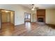 Living room with hardwood floors, brick fireplace, and access to other rooms at 4452 Huntington Dr, Gastonia, NC 28056