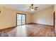 Living room with hardwood floors, sliding doors to deck, and ceiling fan at 4452 Huntington Dr, Gastonia, NC 28056