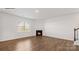 Living room featuring hardwood floors, corner fireplace, and natural light at 453 Court House Ave, York, SC 29745