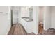 Well-lit bathroom with double vanity sinks and wood-look vinyl flooring at 4618 Harris Elliot Rd, Lincolnton, NC 28092