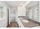 Bathroom with gray countertop and dual sinks reflecting views into the bedroom and the bathroom door at 4618 Harris Elliot Rd, Lincolnton, NC 28092