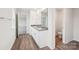 Bathroom showcasing dual sinks, a large mirror reflecting a doorway and toilet, and stylish vinyl flooring at 4618 Harris Elliot Rd, Lincolnton, NC 28092