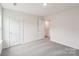 This bedroom features neutral walls, carpeted floors, a closet, and a door to the hallway at 4618 Harris Elliot Rd, Lincolnton, NC 28092