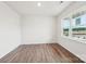Bright bedroom featuring wood floors, white walls, and a large window with natural light at 4618 Harris Elliot Rd, Lincolnton, NC 28092